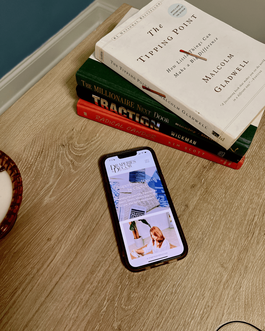 a phone on a table next to books